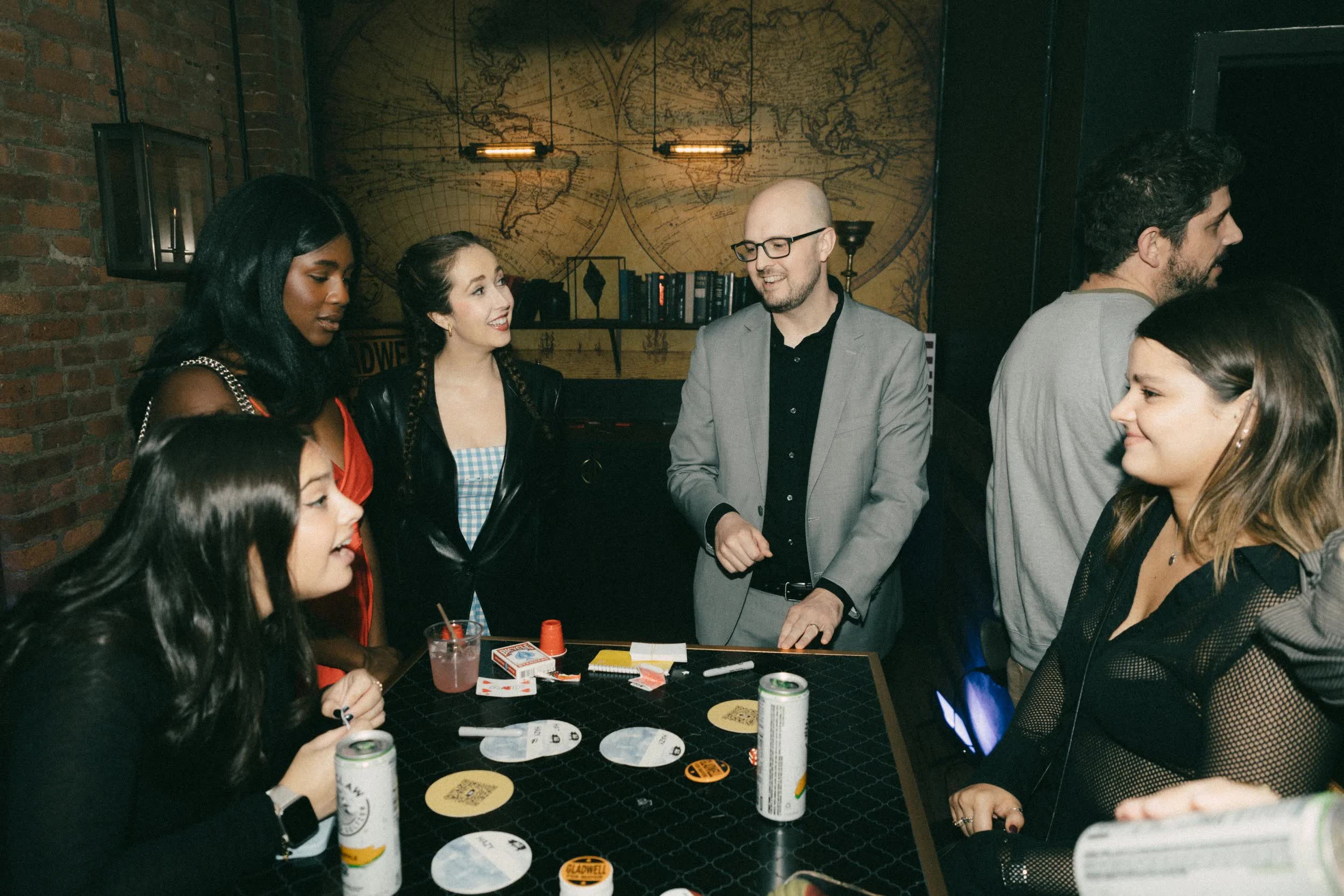 Seth Dale performing a parlor magic show for a seated group